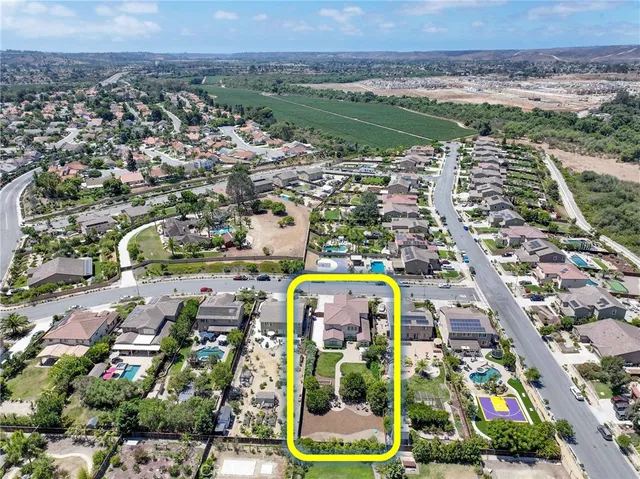 an aerial view of residential houses with outdoor space and street view