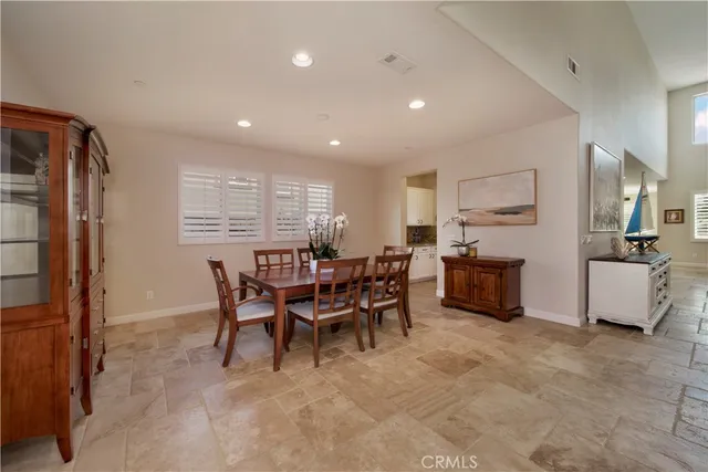 a view of a dining room with furniture and a window