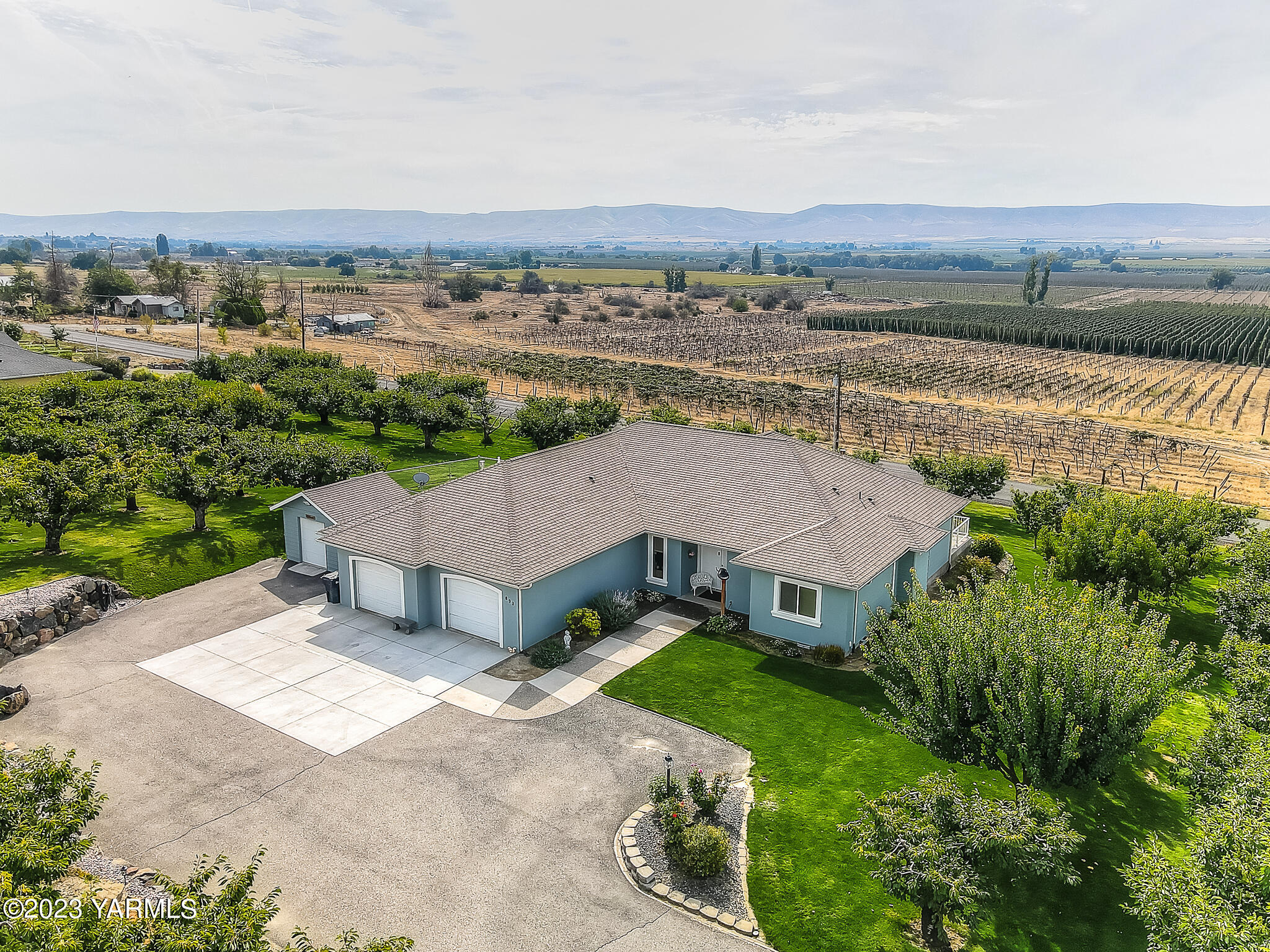 893 Charvet Road Grandview, WA 98930 - Photo 8 of 44 an aerial view of a house with a yard and lake view