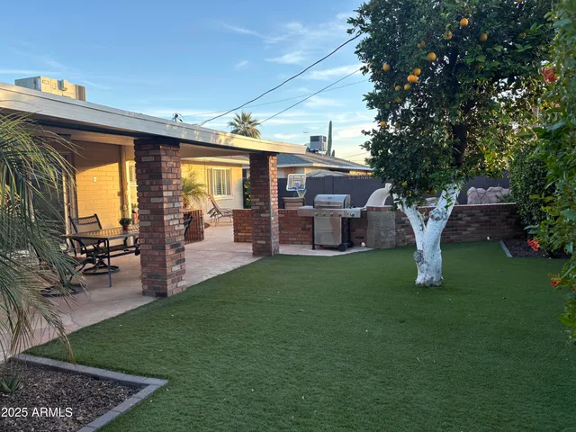 a view of a house with backyard porch and sitting area