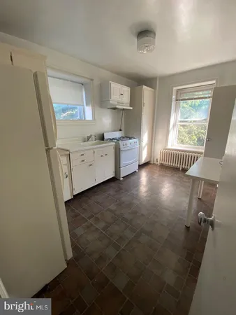 a room with a washing machine and a window
