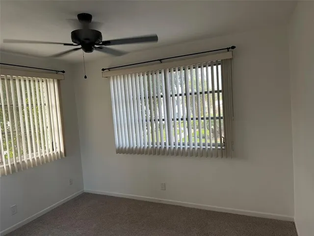 a view of an empty room and a window