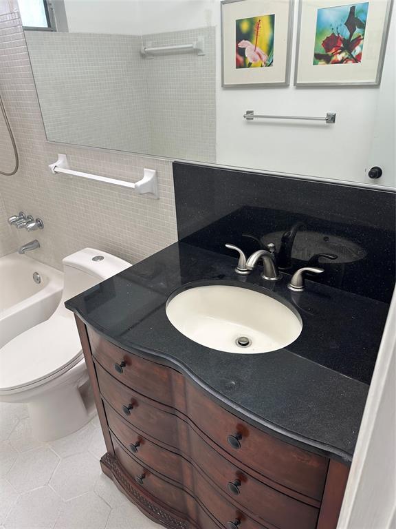 1821 Northeast 62nd Street, Unit 432 Fort Lauderdale, FL 33308 - Photo 16 of 29 a bathroom with a sink and a mirror