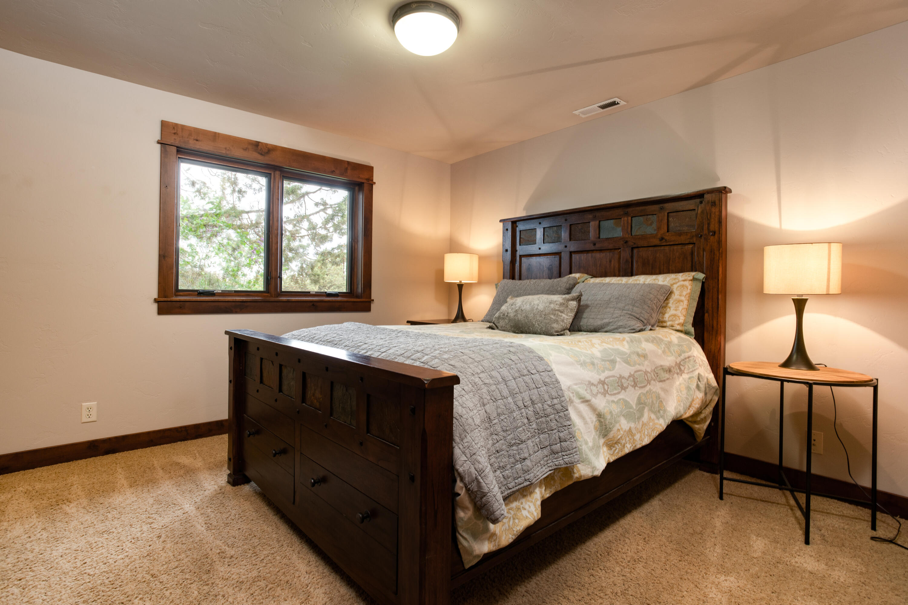 61405 Ward Road Bend, OR 97702 - Photo 16 of 37 a bedroom with a bed and window