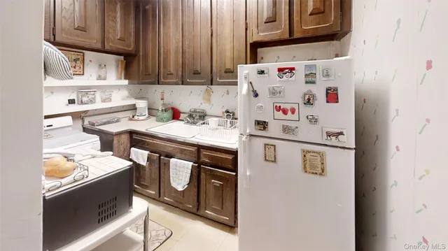 a kitchen with stainless steel appliances granite countertop a sink and a refrigerator