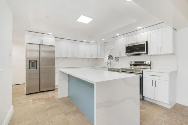 a kitchen with cabinets stove and a sink