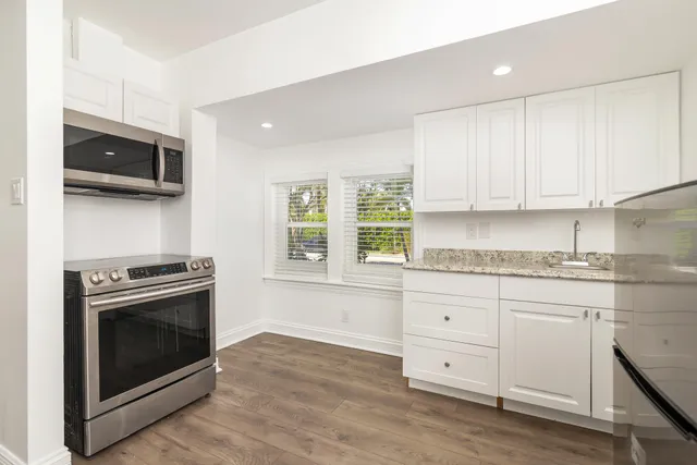 a kitchen with a refrigerator and window