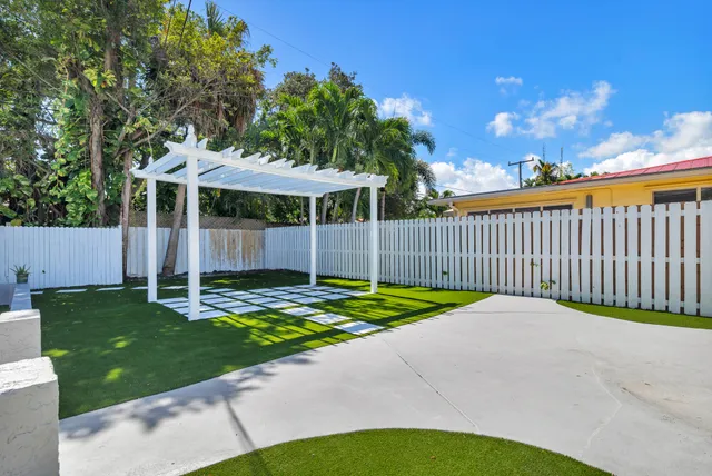an aerial view of a house with a yard basket ball court and outdoor seating