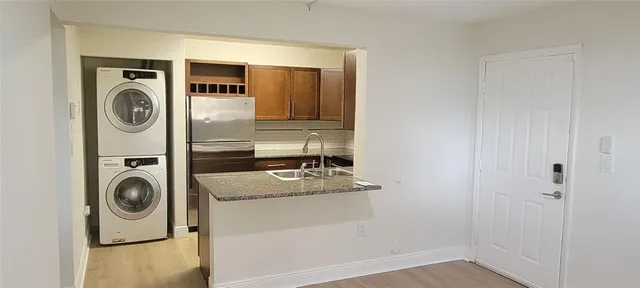 a bathroom with a sink and washer dryer