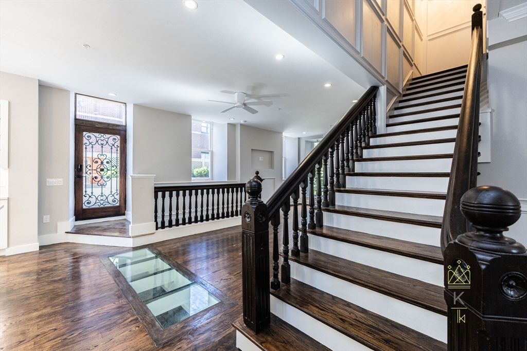 a view of entryway and hall with wooden floor