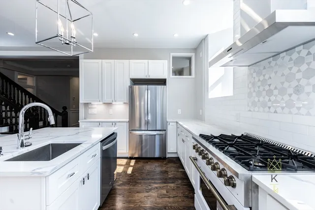 a kitchen with granite countertop a sink and white stainless steel appliances