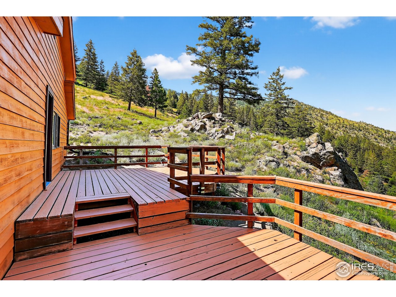 192 Nugget Hill Road Jamestown, CO 80455 - Photo 14 of 25 a view of a wooden deck with furniture