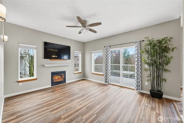 a view of a livingroom with a fireplace wooden floor and window