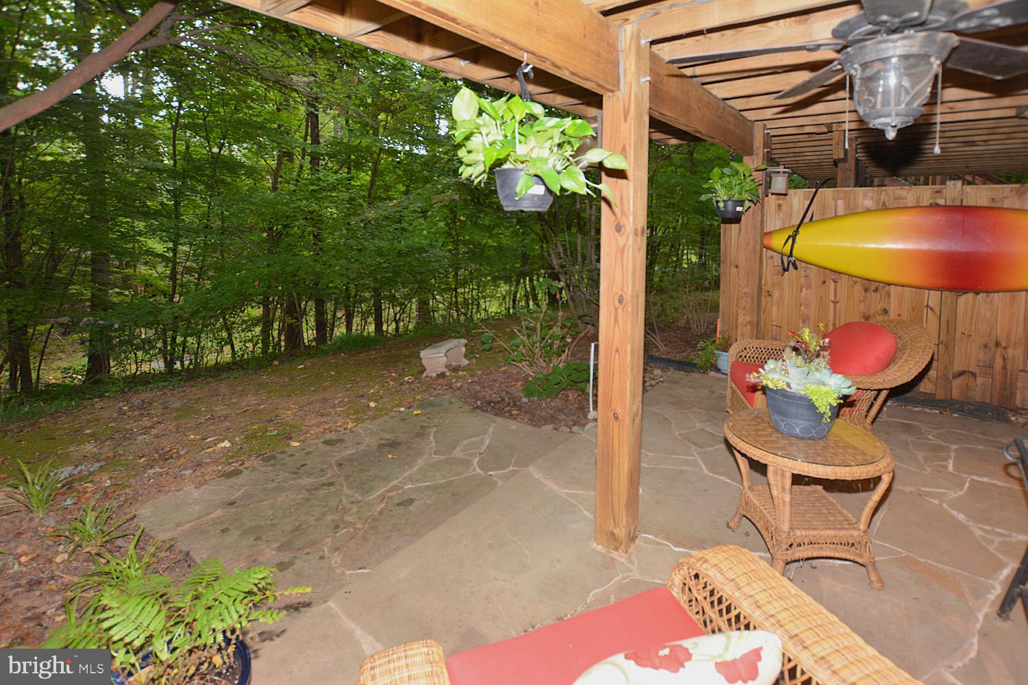 11268 Fairwind Way Reston, VA 20190 - Photo 34 of 51 Stone patio with ceiling fan overlooking tree area