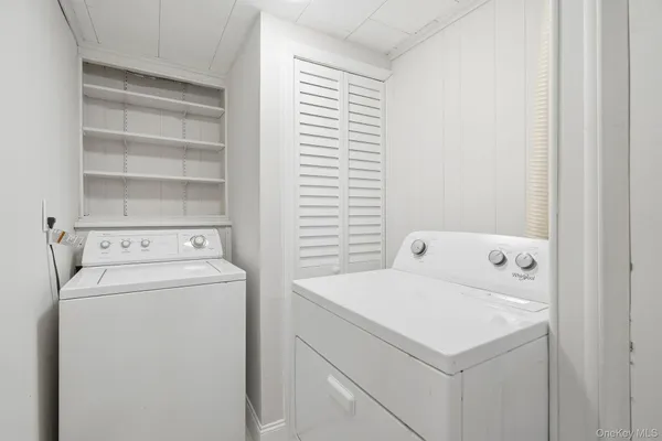 a bathroom with a tub sink toilet and mirror