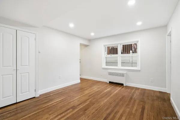 a kitchen with wooden floors and stainless steel appliances