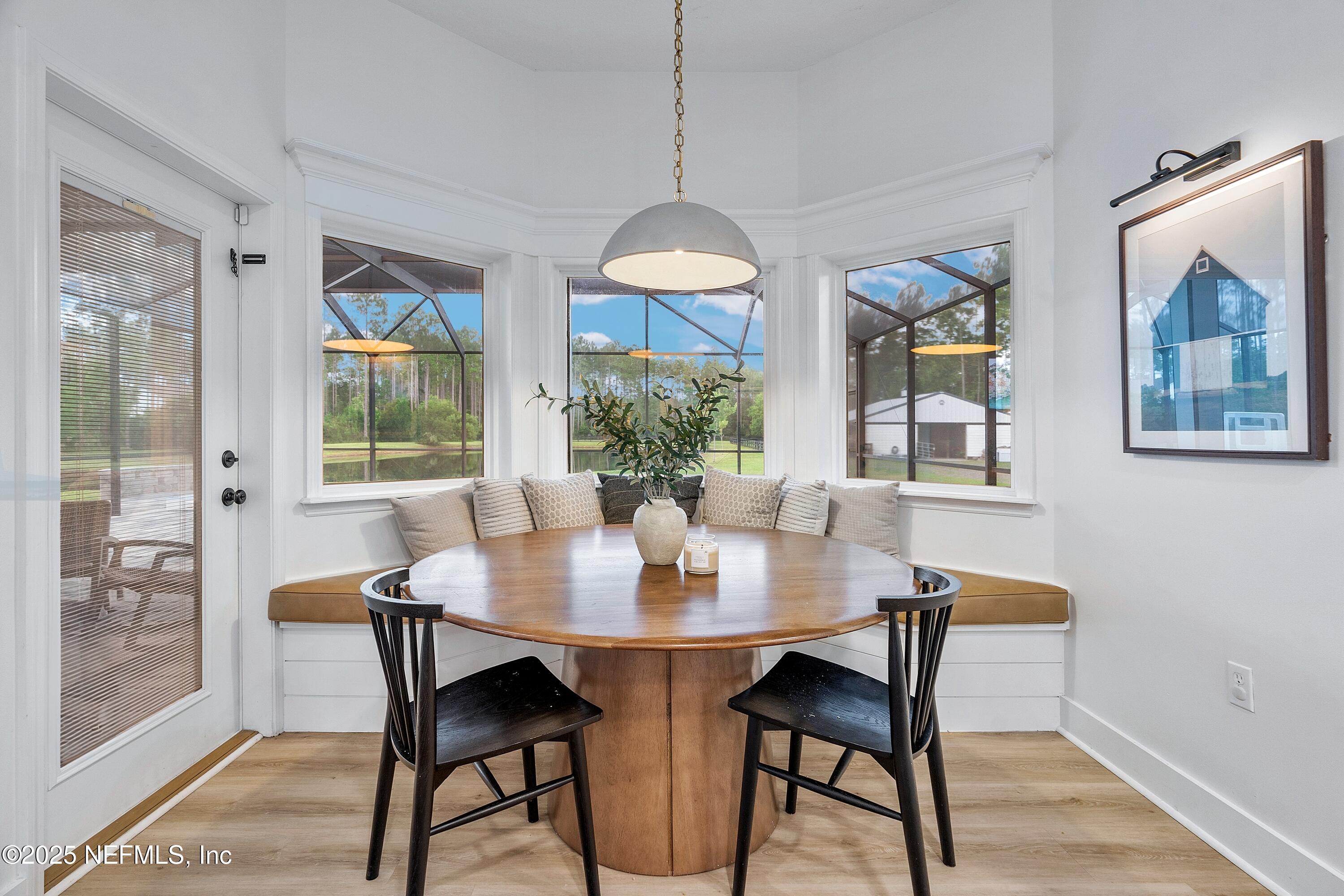 201 Burghley Avenue St. Augustine, FL 32092 - Photo 20 of 75 a dining room with furniture a chandelier and wooden floor