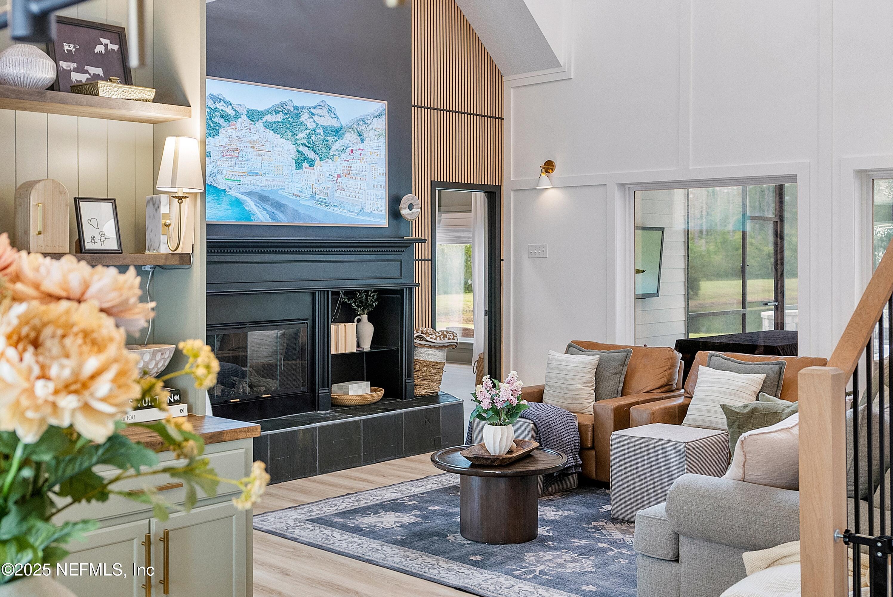 201 Burghley Avenue St. Augustine, FL 32092 - Photo 6 of 75 a living room with furniture a flat screen tv and a fireplace