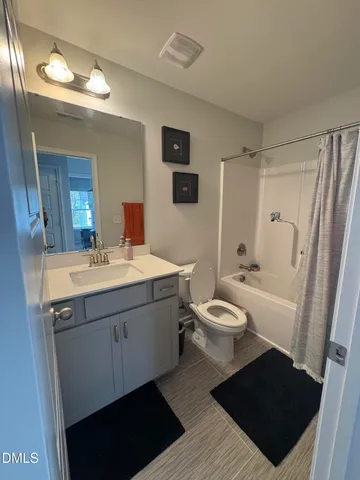 a bathroom with a sink toilet a mirror and shower