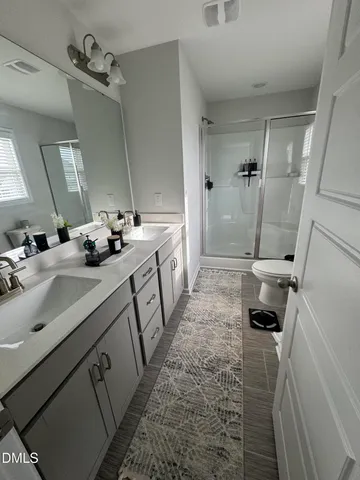 a bathroom with double vanity sink and mirror