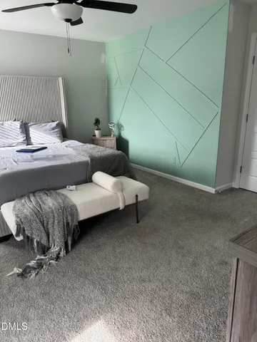 a bedroom with a bed and a potted plant