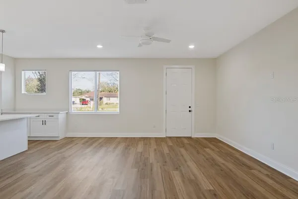 a view of a room with wooden floors and cabinet