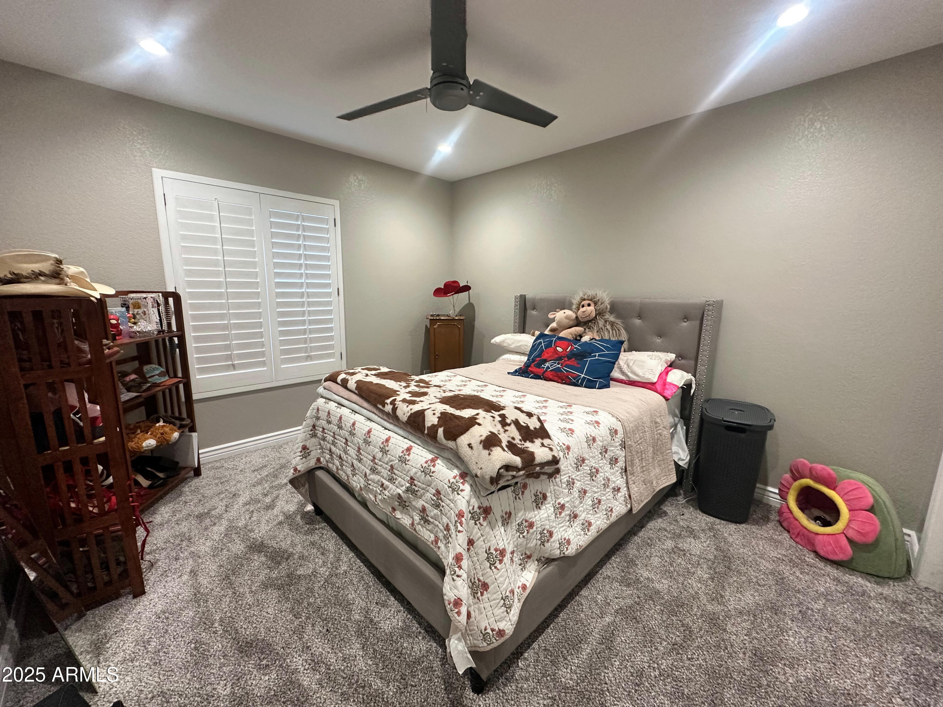 7732 West Wagoner Road Glendale, AZ 85308 - Photo 17 of 30 a bedroom with a bed and a chandelier