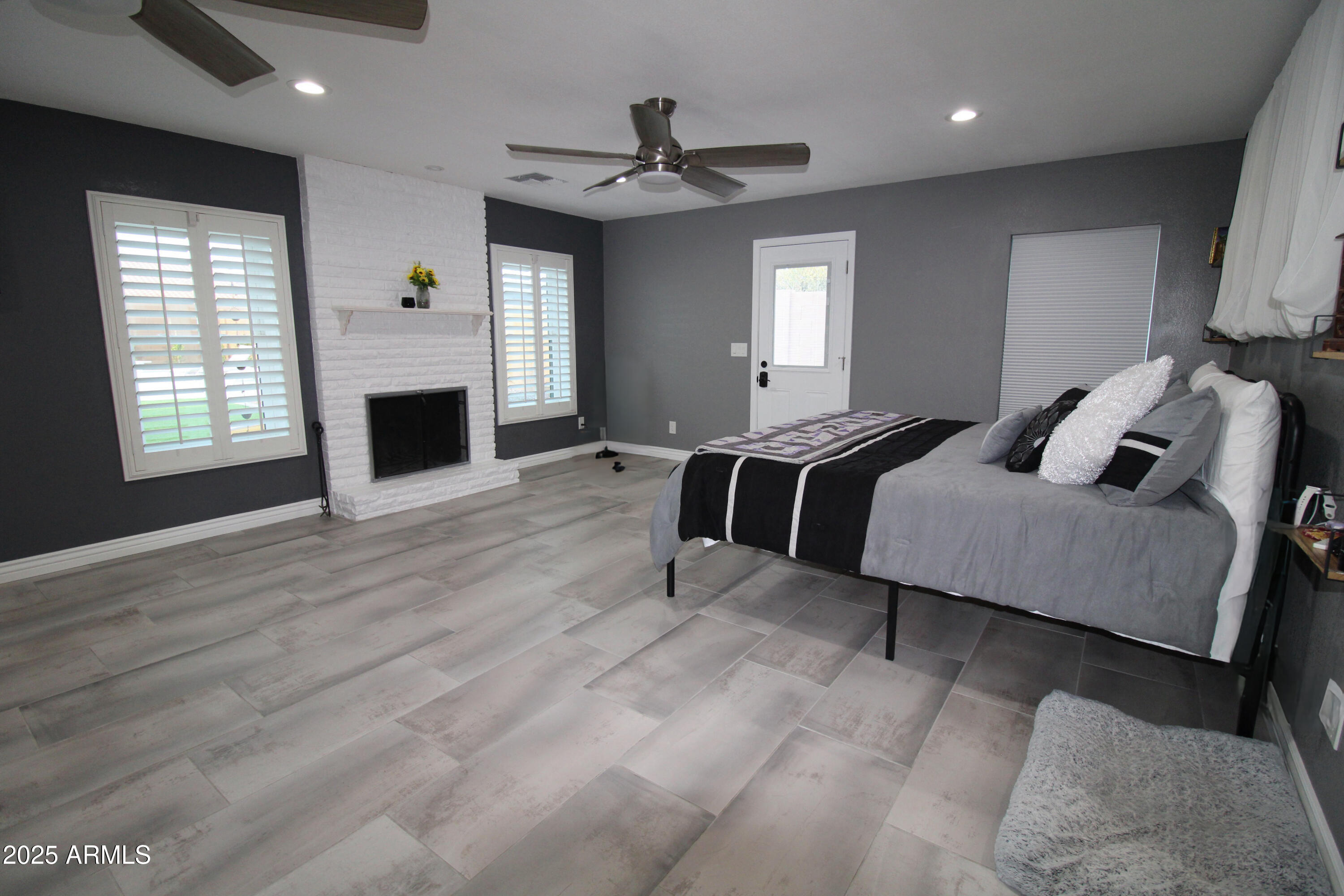 7732 West Wagoner Road Glendale, AZ 85308 - Photo 21 of 30 a spacious bedroom with a bed and a couch