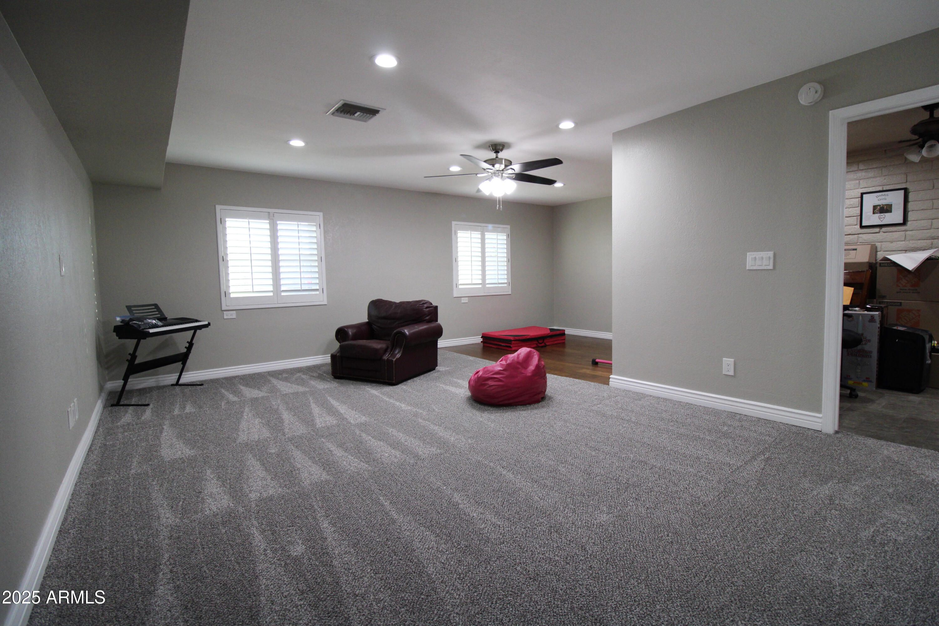 7732 West Wagoner Road Glendale, AZ 85308 - Photo 24 of 41 a living room with furniture a chandelier and a window