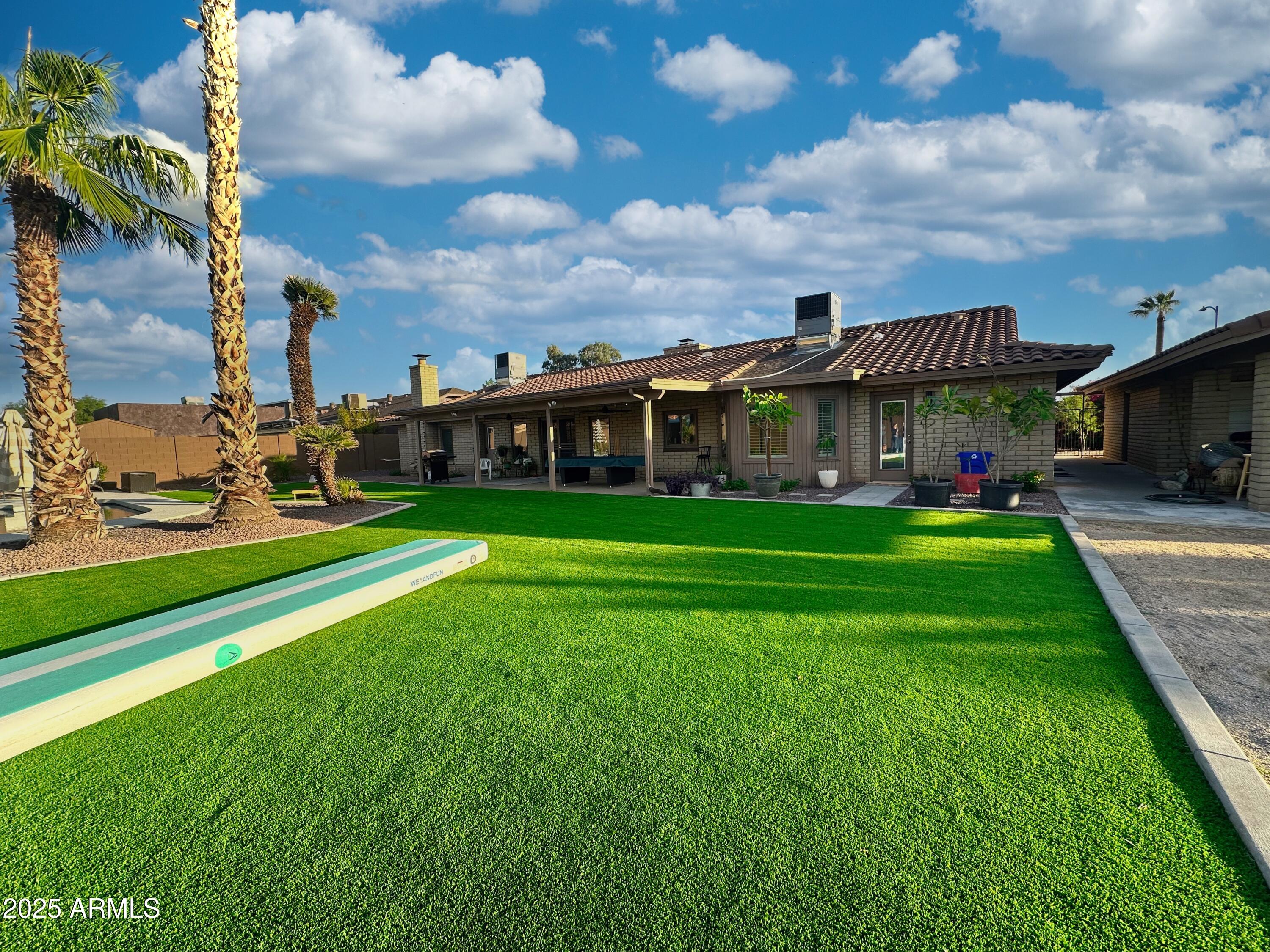7732 West Wagoner Road Glendale, AZ 85308 - Photo 27 of 30 a view of yard with swimming pool and green space