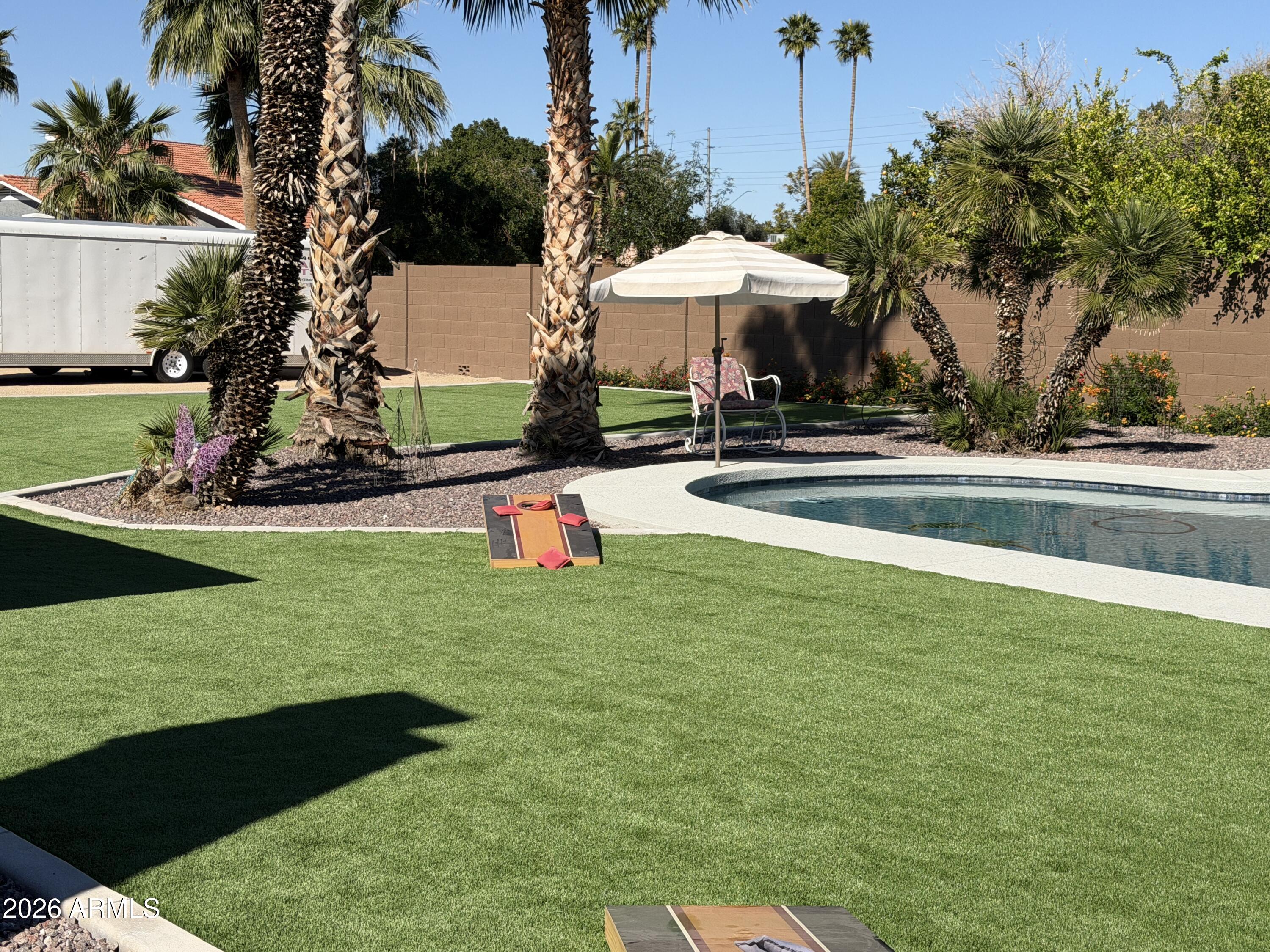 7732 West Wagoner Road Glendale, AZ 85308 - Photo 29 of 41 a view of a swimming pool and lounge chairs in the patio