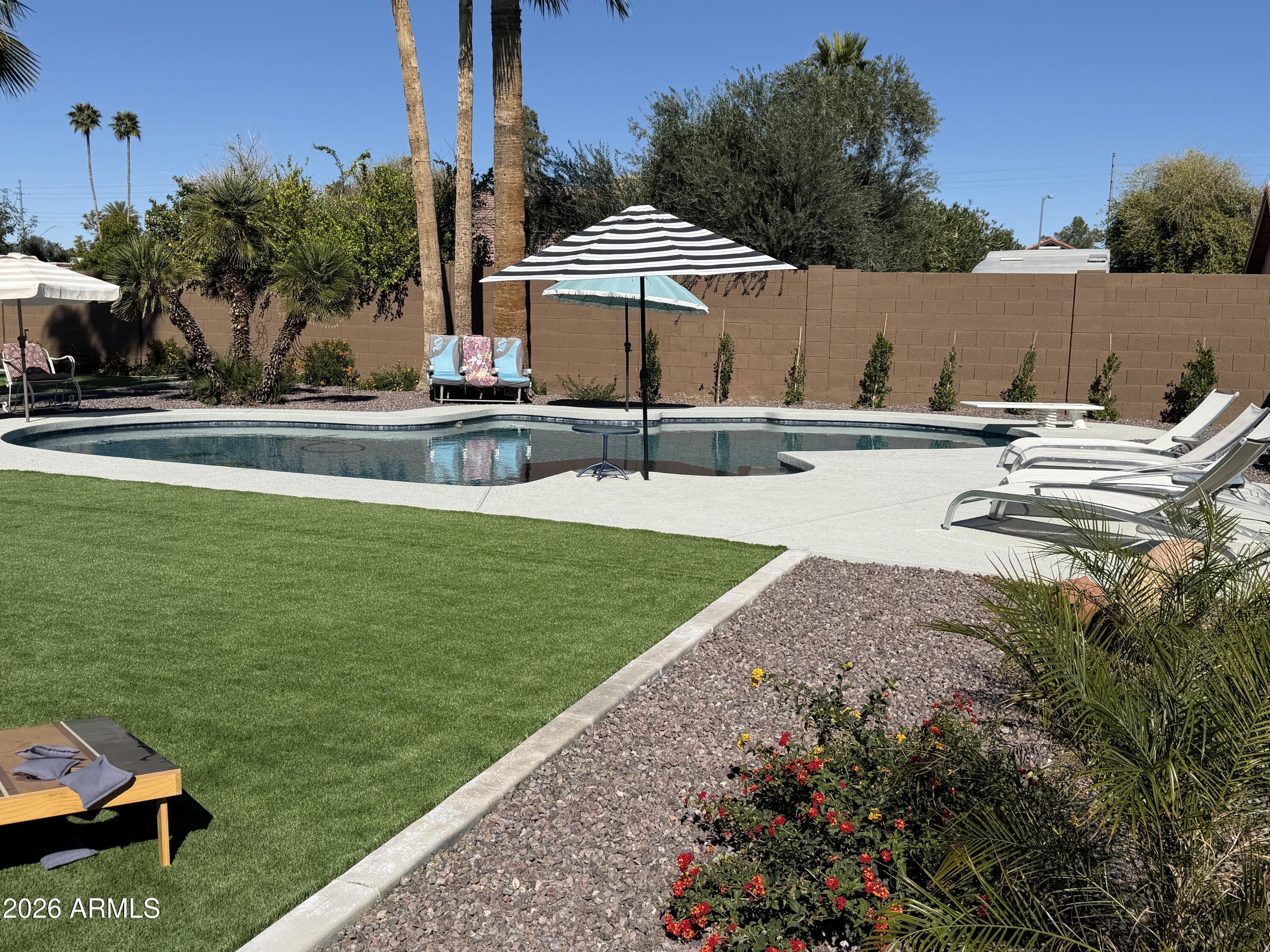 7732 West Wagoner Road Glendale, AZ 85308 - Photo 30 of 41 a view of a house with swimming pool and sitting area