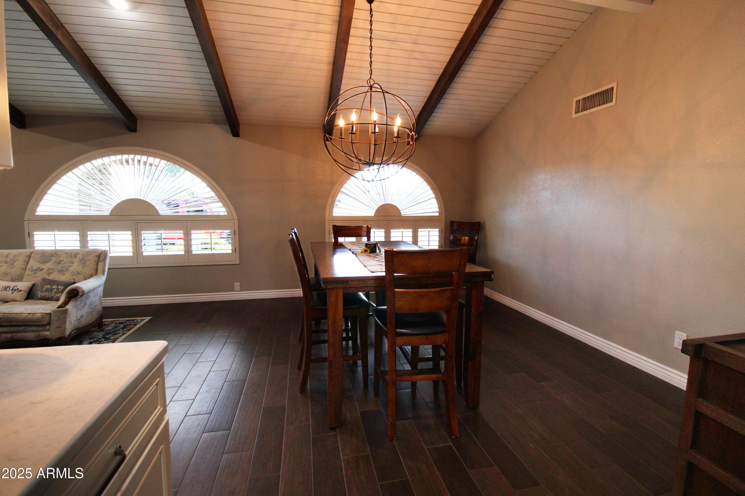 7732 West Wagoner Road Glendale, AZ 85308 - Photo 3 of 30 a view of a dining room with furniture window and wooden floor