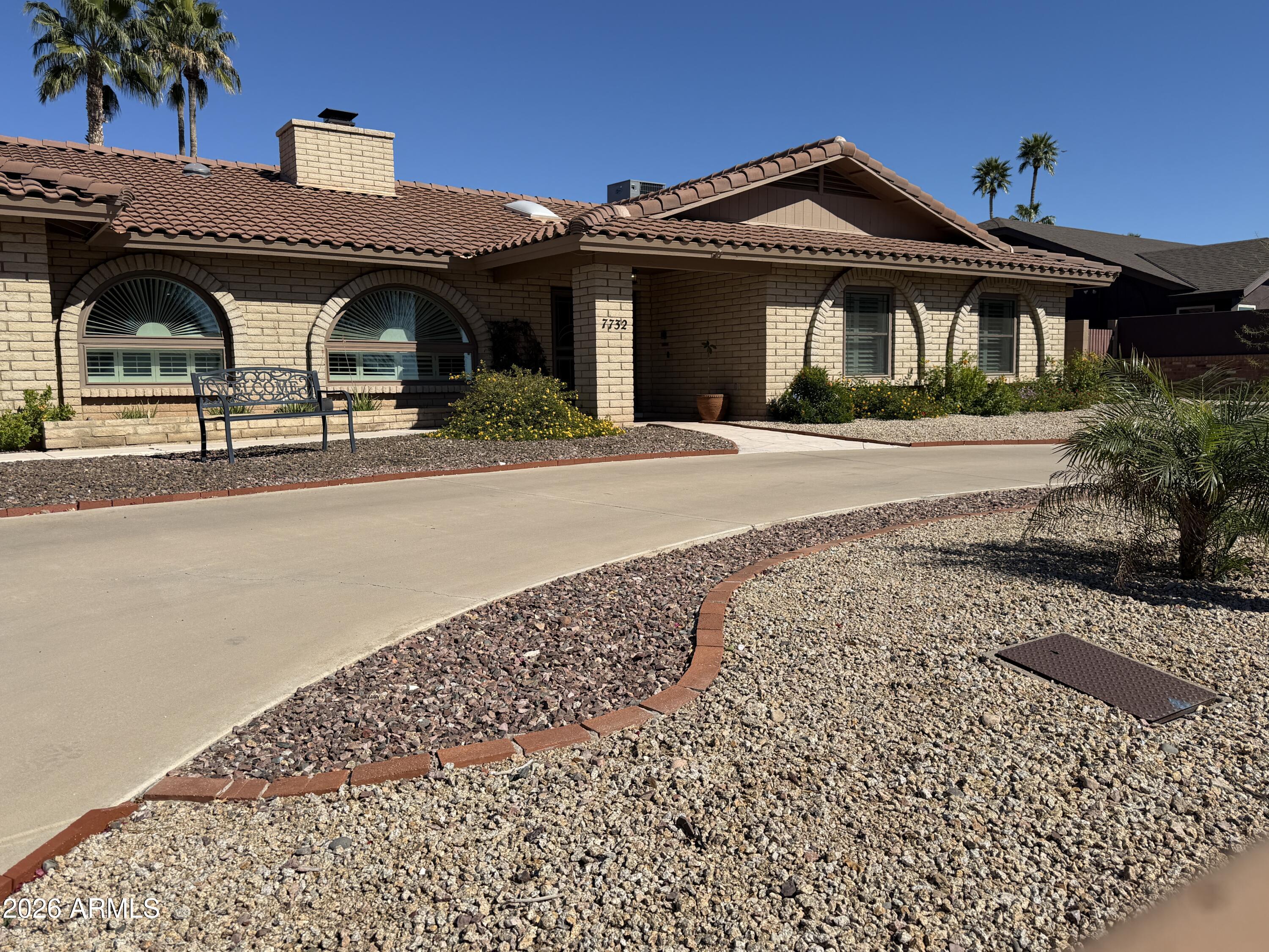 7732 West Wagoner Road Glendale, AZ 85308 - Photo 32 of 41 a front view of a house with garden