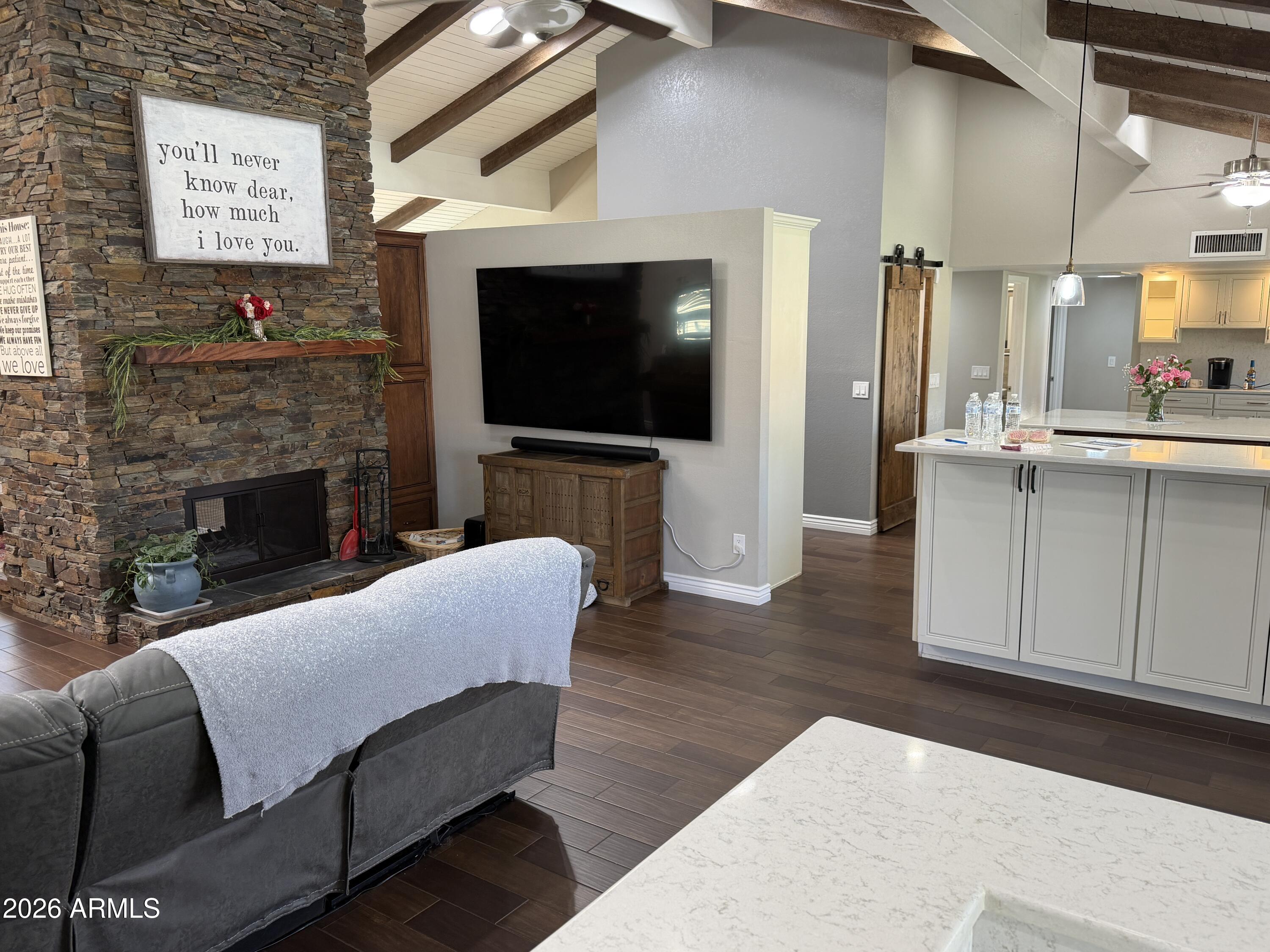 7732 West Wagoner Road Glendale, AZ 85308 - Photo 36 of 41 a living room with furniture a flat screen tv and a fireplace