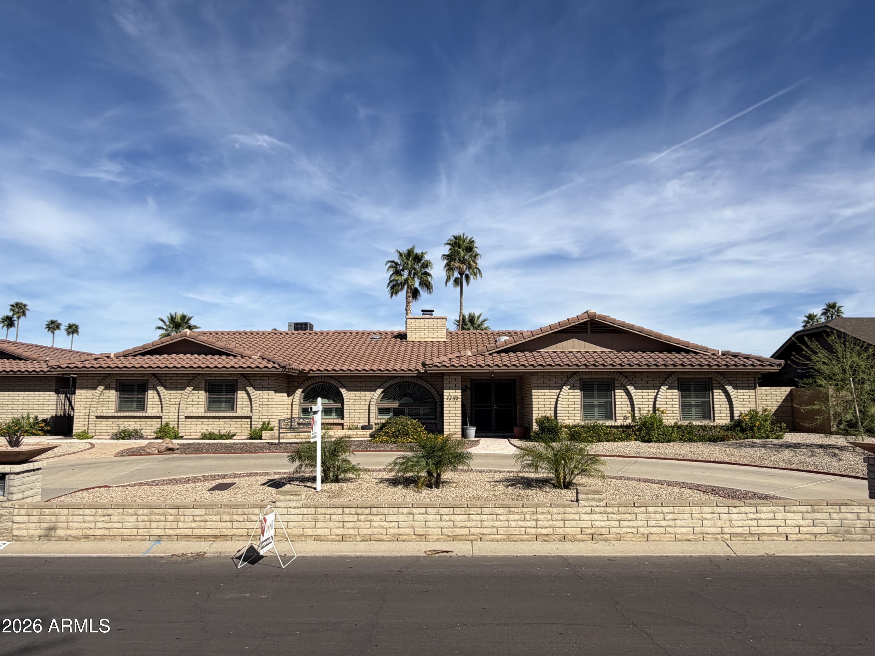7732 West Wagoner Road Glendale, AZ 85308 - Photo 39 of 41 a view of a white house with a sink and a yard