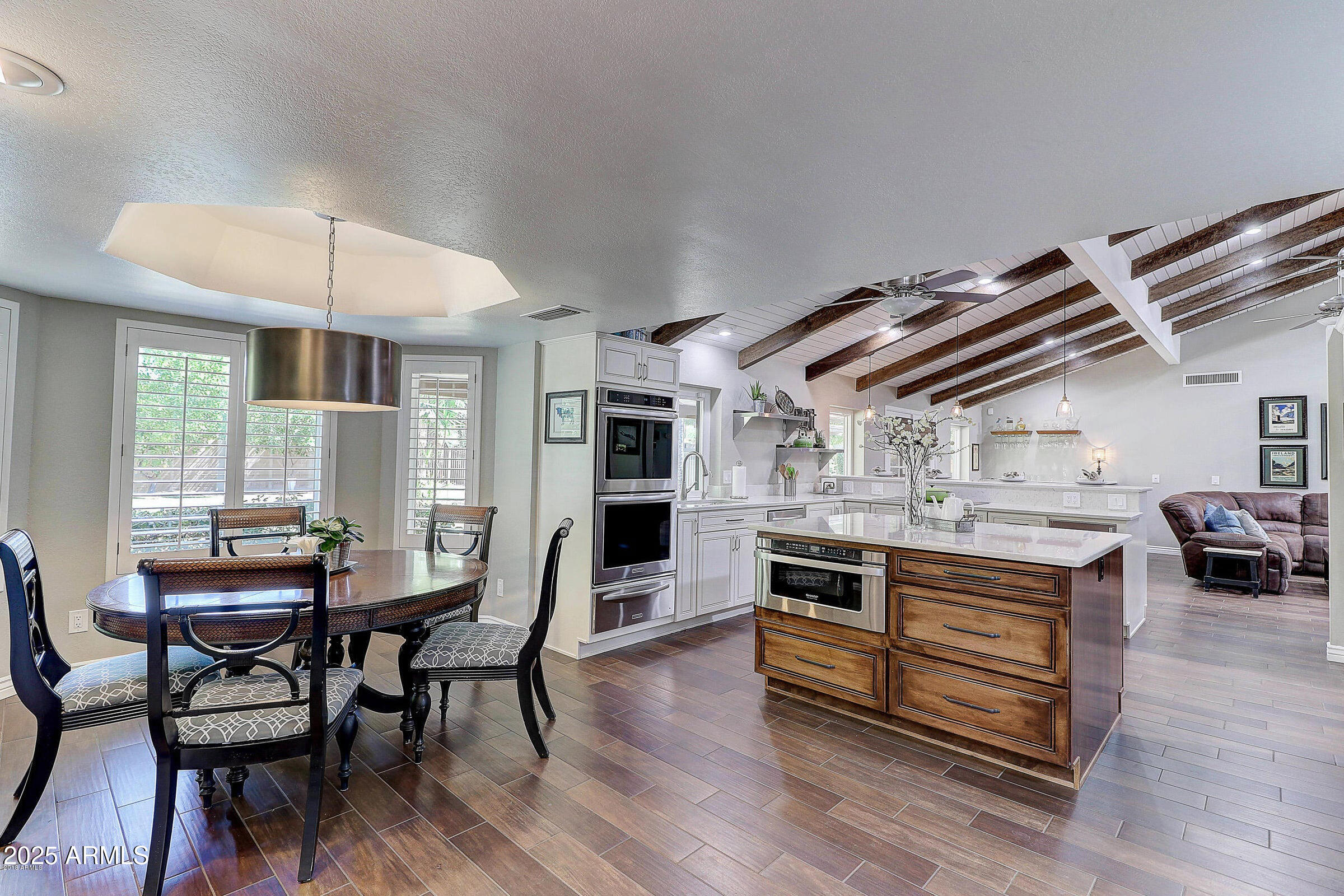 7732 West Wagoner Road Glendale, AZ 85308 - Photo 5 of 41 a kitchen with kitchen island stainless steel appliances a dining table and chairs