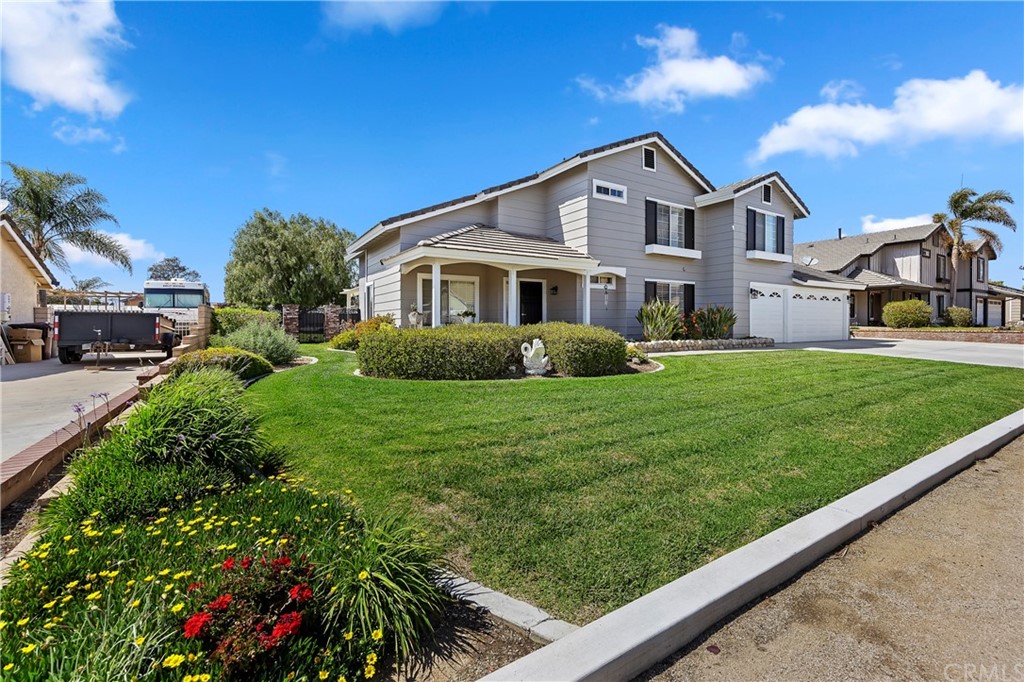 a front view of a house with a garden