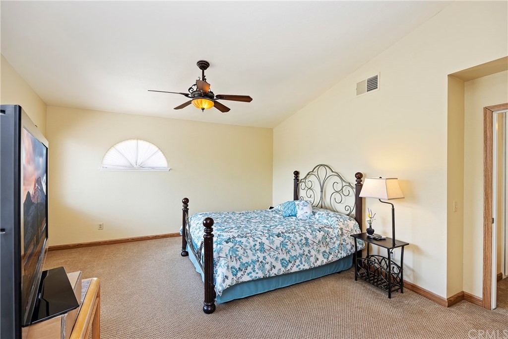 3534 Broken Feather Drive Norco, CA 92860 - Photo 19 of 33 a bedroom with a bed and a chandelier