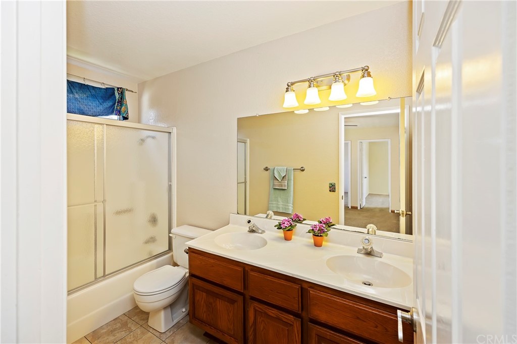 3534 Broken Feather Drive Norco, CA 92860 - Photo 23 of 33 a bathroom with a sink toilet and shower