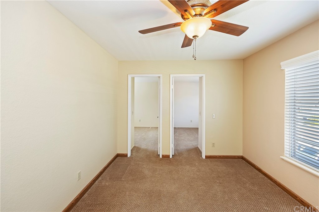 3534 Broken Feather Drive Norco, CA 92860 - Photo 24 of 33 an empty room with a ceiling fan and window