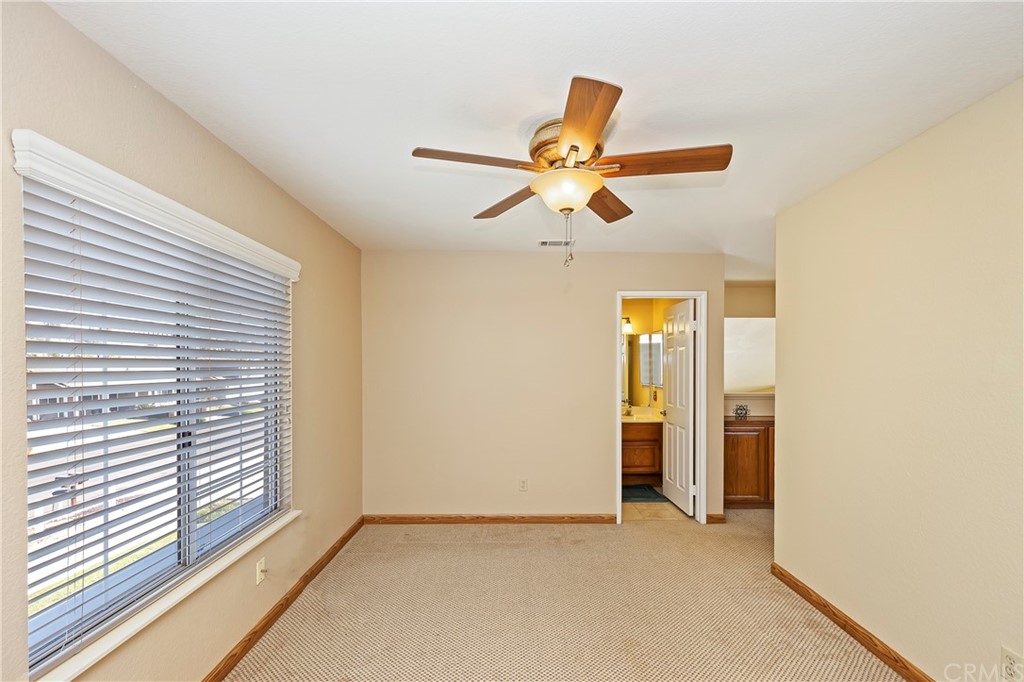 3534 Broken Feather Drive Norco, CA 92860 - Photo 25 of 33 a view of a room with a ceiling fan and a window