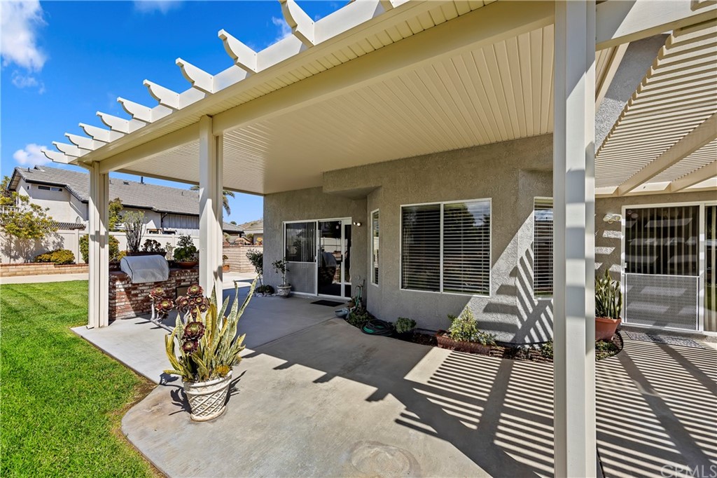 3534 Broken Feather Drive Norco, CA 92860 - Photo 5 of 33 a view of a patio with table and chairs with wooden floor and fence