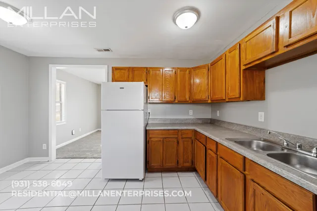 a white refrigerator freezer sitting inside of a kitchen
