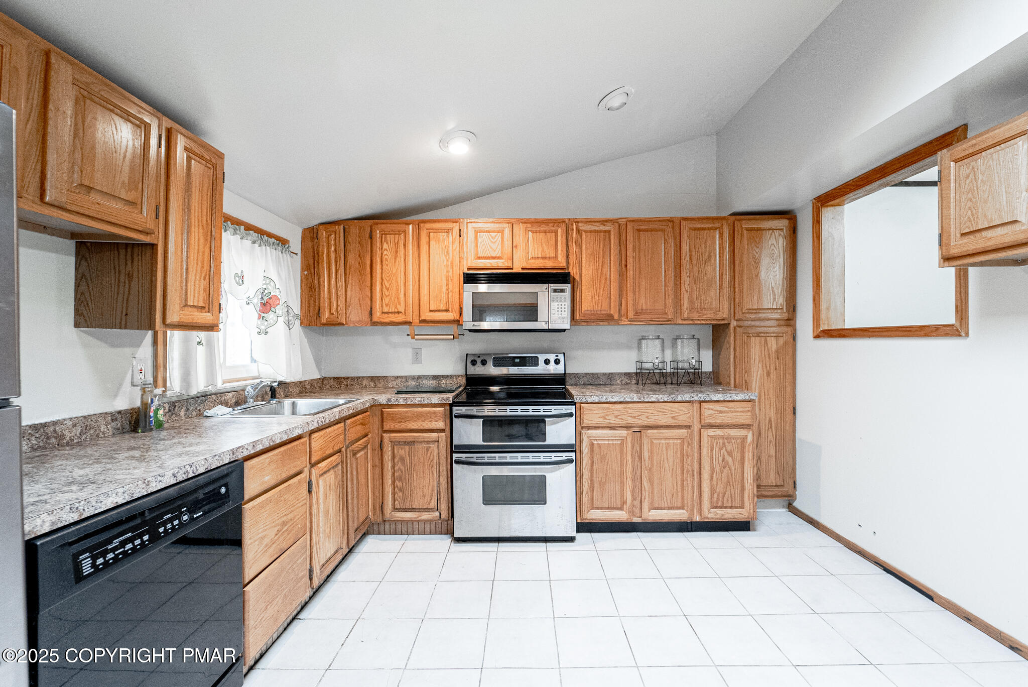 6147 Decker Road Bushkill, PA 18324 - Photo 4 of 49 a kitchen with granite countertop a stove top oven sink and cabinets