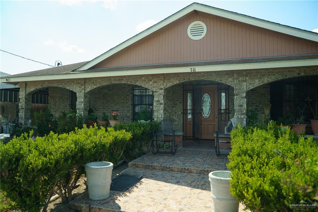 a front view of a house with garden