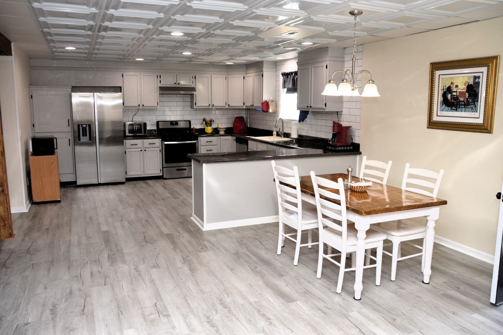 351 Hurricane Creek Road Linden, TN 37096 - Photo 15 of 41 a kitchen with stainless steel appliances a refrigerator a stove a sink dishwasher with a dining table and chairs