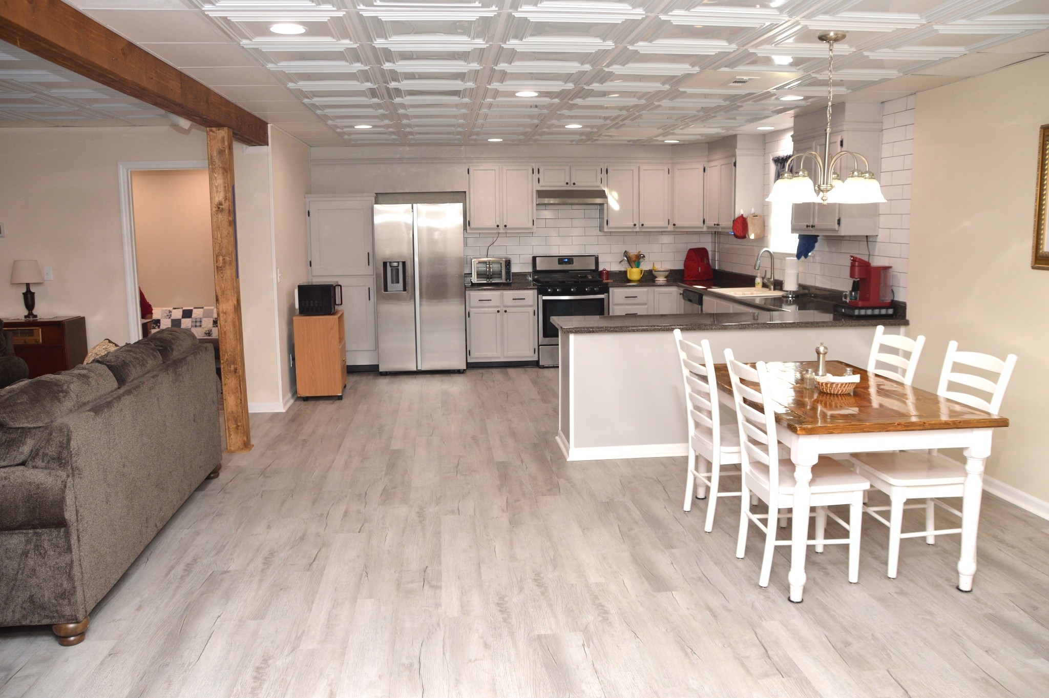351 Hurricane Creek Road Linden, TN 37096 - Photo 16 of 41 a kitchen with stainless steel appliances kitchen island granite countertop a table and chairs in it