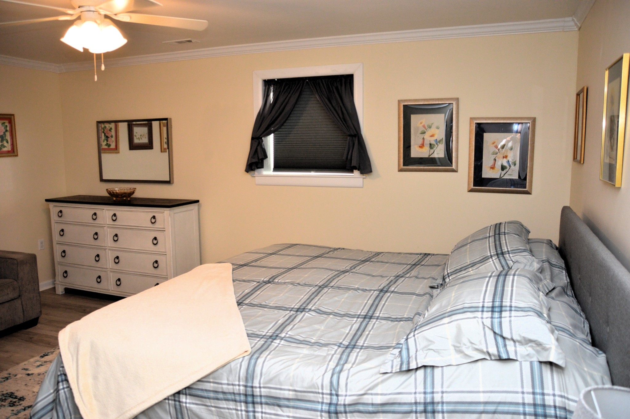 351 Hurricane Creek Road Linden, TN 37096 - Photo 25 of 41 a bedroom with a bed a lamp and a flat screen tv