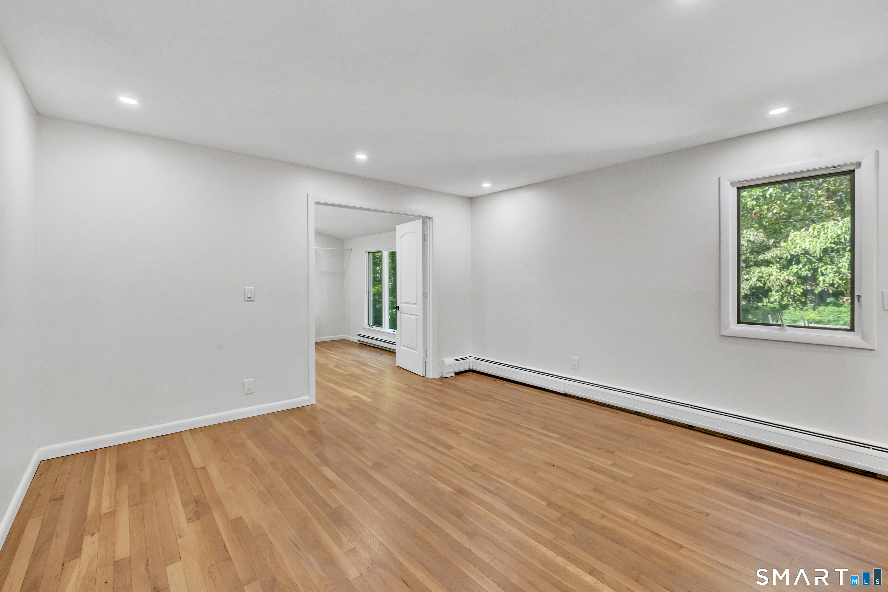 48 Crestwood Road Monroe, CT 06468 - Photo 28 of 32 a view of an empty room with wooden floor and a window